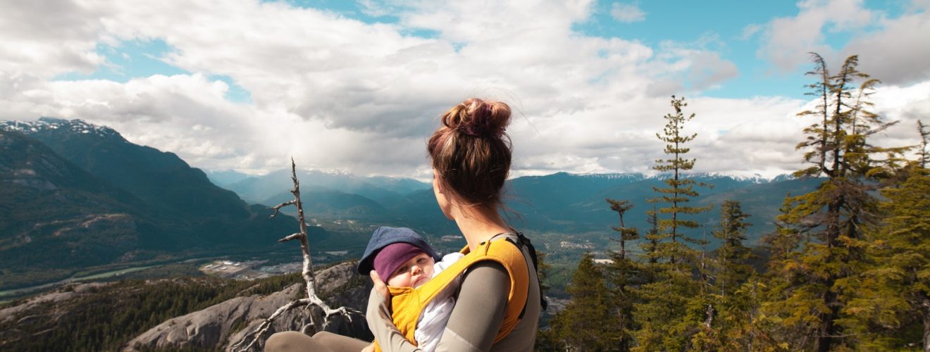 Mother Carrying Her Baby while Looking at the Nature Scenery