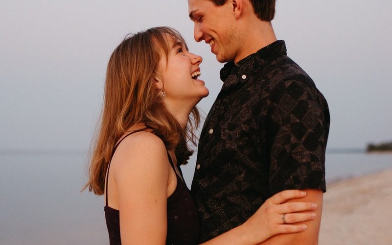 man and woman kissing each other during daytime