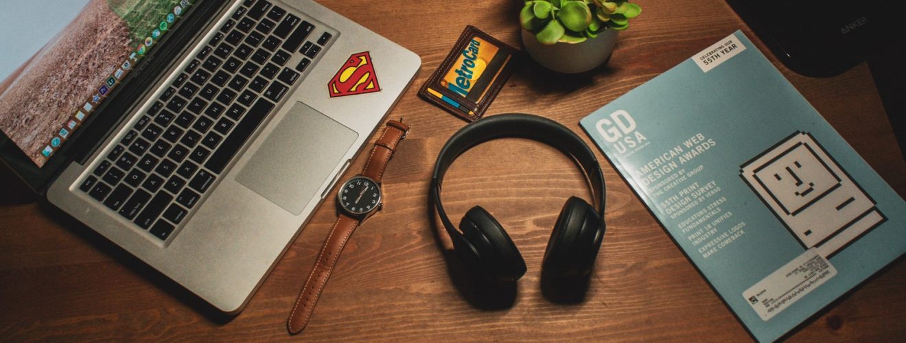 MacBook Pro beside cordless headphones