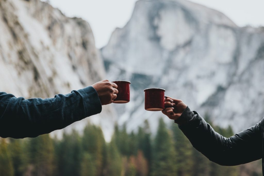 two person holding red mugs as romantic gifts